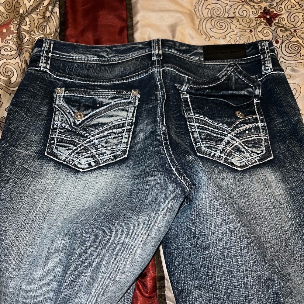 Dark, denim blue jeans with rips. Nice fit and true to size.